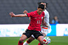 Korea's Hwang Hee-chan, front, and Ivory Coast's Guela Doue vie for the ball during the international friendly soccer match between Korea and Ivory Coast in Milton Keynes in England on March 28. [AP PHOTO/YONHAP]
