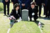 President Lee Jae Myung, right, and first lady Kim Hea Kyung lay flowers at the grave of Yang Chang-geun in northern Gwangju on May 18. Yang was a first-year high school student who was killed by troops sent to crush the pro-democracy uprising in the city in May 1980. [NEWS1]