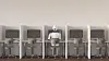 A robot sitting in an office, working alone [GETTY IMAGES]