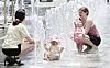 People enjoy the warm weather in front of water fountains in Jongno District, central Seoul, on June 2. [NEWS1]