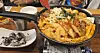 A pan of tteokbokki (spicy rice cake) is served at Superstar Tteokbokki, located near HYBE headquarters in Yongsan District, central Seoul. [SHIN HA-NEE]