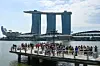 People take pictures at the Marina bay waterfront in Singapore on March 24. [AFP/YONHAP]