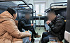 North Korean soldiers, captured by Ukraine during the war with Russia, speak to a South Korean woman, left, at a detention center in Ukraine for prisoners of war, in this photo provided Oct. 31, 2025, by a civic group. [YONHAP]