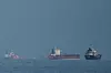 Oil tankers and cargo ships line up in the Strait of Hormuz as seen from Khor Fakkan, United Arab Emirates, on March 11. [AP/YONHAP]