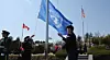 A flag-raising ceremony is held in the symbolic zone of the United Nations Memorial Cemetery in Korea in Busan’s Nam District on March 21, 2024, following the installation of new flagpoles for the first time in 73 years. The project was completed by the United Nations Memorial Cemetery in Korea management office as part of efforts to enhance the cemetery’s commemorative and symbolic significance. [SONG BONG-GEUN]