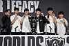 Korea's T1 team poses with a trophy during a press conference as it celebrates its victory against Korea's KT Rolster at the final of the League of Legends World Championship in Chengdu, China, on Nov. 9, 2025. From left are Coach Kim Jeong-gyun, and players 'Doran' or Choi Hyeon-joon, 'Oner' or Mun Hyeon-jun, 'Faker' or Lee Sang-hyeok, 'Gumayusi' or Lee Min-hyeong and 'Keria' or Ryu Min-seok. [AFP/YONHAP]