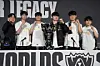 Korea's T1 team poses with a trophy during a press conference as it celebrates its victory against Korea's KT Rolster at the final of the League of Legends World Championship in Chengdu, China, on Nov. 9, 2025. From left are Coach Kim Jeong-gyun, and players 'Doran' or Choi Hyeon-joon, 'Oner' or Mun Hyeon-jun, 'Faker' or Lee Sang-hyeok, 'Gumayusi' or Lee Min-hyeong and 'Keria' or Ryu Min-seok. [AFP/YONHAP]