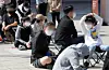 Adults and children appear not to engage while waiting to enter a store on April 17, 2022. [NEWS1]