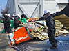 Officials from the Ministry of Land, Infrastructure and Transport, the Aviation and Railway Accident Investigation Board and the scientific investigation unit of the Jeonnam Provincial Police Agency inspect the Jeju Air plane crash wreckage stored behind the airport fire station at Muan International Airport on March 12. [BEREAVED FAMILIES ASSOCIATION FOR THE JEJU AIR PASSENGER PLANE DISASTER AT MUAN INTERNATIONAL AIRPORT]