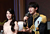 Singer-actor IU, left, listens as her 'Perfect Crown' costar, actor Byeon Woo-seok, speaks during a press conference in southern Seoul on April 6. [NEWS1]