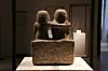 The back of the ancient Egyptian artifact “Statue of Der Senedj and his wife.” The wife is shown placing her arm over her husband’s shoulder. Neues Museum. [Kwack Min-soo]