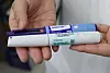 Weight loss medications, Wegovy, front, and Saxenda, are placed on a hand at a pharmacy in central Seoul on Dec. 2, 2024. [YONHAP]