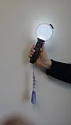 BTS's official ARMY Bomb light stick with a purple 'norigae,' a traditional Korean ornament [SHIN HA-NEE]