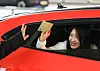 Short track speed skater Kim Gil-li leaves Incheon International Airport Terminal 2 in Incheon on Feb. 24 in a Lamborghini after returning to Korea. [YONHAP]