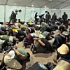 A still from footage uploaded to Israeli National Security Minister Itamar Ben-Gvir's X account shows detained activists handcuffed and kneeling on the ground. [SCREEN CAPTURE]