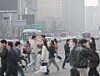 Pedestrians walk across the Sejong-daero intersection near Gwanghwamun in central Seoul on March 27. [YONHAP]