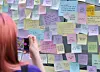 A person takes a photo of messages posted at Exit 10 of Gangnam Station in southern Seoul on May 17 during an event marking the 10th anniversary of the Gangnam Station murder case. [YONHAP]