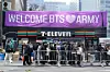 People pass by a banner for BTS ahead of a comeback concert of the K-pop band near Gwanghwamun Square in Jongno District, central Seoul, on March 20. [AP/YONHAP]