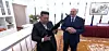 North Korean leader Kim Jong-un, left, holds up an assault rifle given by Belarusian President Aleksandr Lukashenko during his state visit in Pyongyang on March 26 in this screen grab from Belarus's news agency BelTA. [SCREEN CAPTURE]