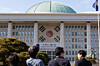 People stand in front of the main building of the National Assembly in western Seoul in a photo from Feb. 27. [NEWS1]