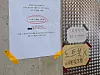 Notices taped to a cafe wall warn customers that laptops and tablets are not permitted [SEO JI-EUN]