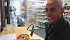A still from a video uploaded by Johnny Somali on Oct. 17, 2024, shows the streamer hurling insults while inside a convenience store in Korea. In the same video, he is shown intentionally spilling ramyeon onto the table. [SCREEN CAPTURE]