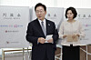 President Lee Jae Myung, left, and first lady Kim Hea Kyung walk out of the polling booth holding their votes during early voting in Jongno District, central Seoul, on May 29. [YONHAP]