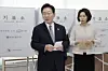 President Lee Jae Myung, left, and first lady Kim Hea Kyung walk out of the polling booth holding their votes during early voting in Jongno District, central Seoul, on May 29. [YONHAP]