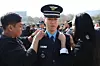 Family members of a newly commissioned officer pin on his insignia during a joint commissioning ceremony at the parade ground of Gyeryongdae in Gyeryong, South Chungcheong, on Feb. 20. [NEWS1]