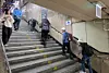 People walk up and down the stairs connecting Cheongnyangni Station to the subway platform. [SHIN SUNG-SIK]