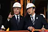 Prime Minister Kim Min-seok speaks with Canadian Prime Minister Mark Carney as they tour the Hanwha Ocean Shipyard in Geoje Island, South Gyeongsang, on Oct. 30, 2025. [AP/YONHAP]