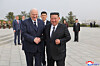 Belarusian President Alexander Lukashenko, left, shakes hands with North Korean leader Kim Jong-un as he visits the Liberation Tower, honoring the former Soviet war dead, in Pyongyang on March 25, in this photo released by the Korean Central News Agency the next day. [YONHAP]