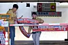 Public servants attach a banner notifying users of the two-day rotation driving and parking system at a parking space at Buk District Office in Gwangju on April 7. [BUK DISTRICT]