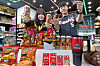 Models pose with limited-edition “Mighty Tigers” products, a collaboration between 7-Eleven and baseball club Kia Tigers, on May 3. From beer to transportation cards and chips, nine products will be launched on May 13. [7-ELEVEN]