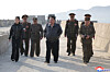 North Korean leader Kim Jong-un, center, walks with military officials as he observes the Hwasong-11 Ra surface-to-surface tactical ballistic missile being test-fired at an unspecified location, in this file photo from April 19, to verify the characteristics and power of a cluster bomb warhead and fragmentation mine warhead applied to the tactical ballistic missile, in this photo released by the North's official Korean Central News Agency the next day. [YONHAP]