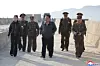 North Korean leader Kim Jong-un, center, walks with military officials as he observes the Hwasong-11 Ra surface-to-surface tactical ballistic missile being test-fired at an unspecified location, in this file photo from April 19, to verify the characteristics and power of a cluster bomb warhead and fragmentation mine warhead applied to the tactical ballistic missile, in this photo released by the North's official Korean Central News Agency the next day. [YONHAP]