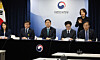 Finance Minister Koo Yun-cheol, center, speaks to reporters at the government complex in central Seoul on March 26. [YONHAP]
