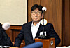 People Power Party Rep. Kweon Seong-dong sits in a courtroom after attending the first hearing in a case over allegations of receiving illegal political funds from the Unification Church at the Seoul Central District Court in southern Seoul on Nov. 3, 2025. [JOINT PRESS CORPS]
