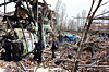Officials and media representatives gather around a damaged building of the Shahid Beheshti University in Tehran on April 4, following a strike. [AFP/YONHAP]