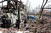 Officials and media representatives gather around a damaged building of the Shahid Beheshti University in Tehran on April 4, following a strike. [AFP/YONHAP]