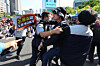A protester is restrained during a rally at Gwanghwamun Square in central Seoul on May 1. [NEWS1]