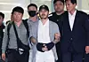 Park Wang-yeol, a suspected drug kingpin who killed three Korean nationals in the Philippines, escaped prison and allegedly trafficked narcotics into Korea, is escorted through Incheon International Airport on March 25. [YONHAP]