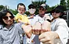 Members of a family hold up the backs of their hands after voting outside a polling station set up at Yeouido Middle School in Yeongdeungpo District, Seoul, on June 3, the day of the local elections. [YONHAP]