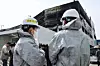 Investigators are seen outside an auto parts factory in Daedeok District, Daejeon, on March 22 after a fire broke out at the facility on March 20. [NEWS1]