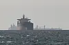 Cargo ships in the Gulf, near the Strait of Hormuz, as seen from northern Ras al-Khaimah, near the border with Oman’s Musandam governance, amid the U.S.-Israeli conflict with Iran, in the United Arab Emirates on March 11. [REUTERS/YONHAP]