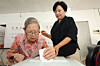 An 111-year-old woman casts her ballot at a voting station in Dong District, Gwangju, for the local elections on June 3. [NEWS1]