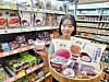 A model poses with six new ube-based products unveiled by convenience store chain CU on April 27, featuring the purple yam popular in Filipino cuisine. [YONHAP]