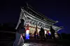 A visitor walks through the grounds of Changdeok Palace during a nighttime Moonlight Tour in Jongno District, central Seoul, on April 14. [JOONGANG ILBO]