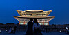 Two people take a photo during the evening opening of Gyeongbok Palace on May 8, 2025. [NEWS1]