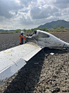 Firefighters inspect the wreckage of a light aircraft that crashed in Haenam County in South Jeolla Province on May 23. [JEONNAM FIRE SERVICES HEADQUARTERS]